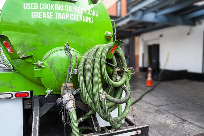 a vacuum truck pumping out a large underground grease trap in Dupont, WA